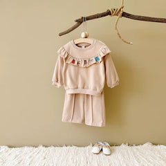 long-sleeve flounce top with embroidered mini icons