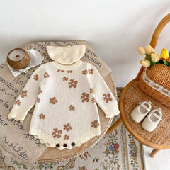 Floral knit baby onesie with scalloped hem
