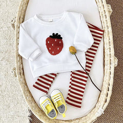 Close-up of strawberry patch on baby sweatshirt
