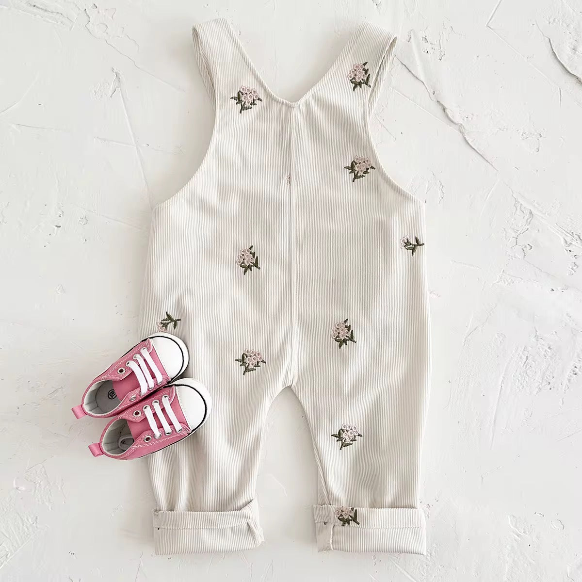 Embroidered floral baby overalls in soft cream corduroy back view