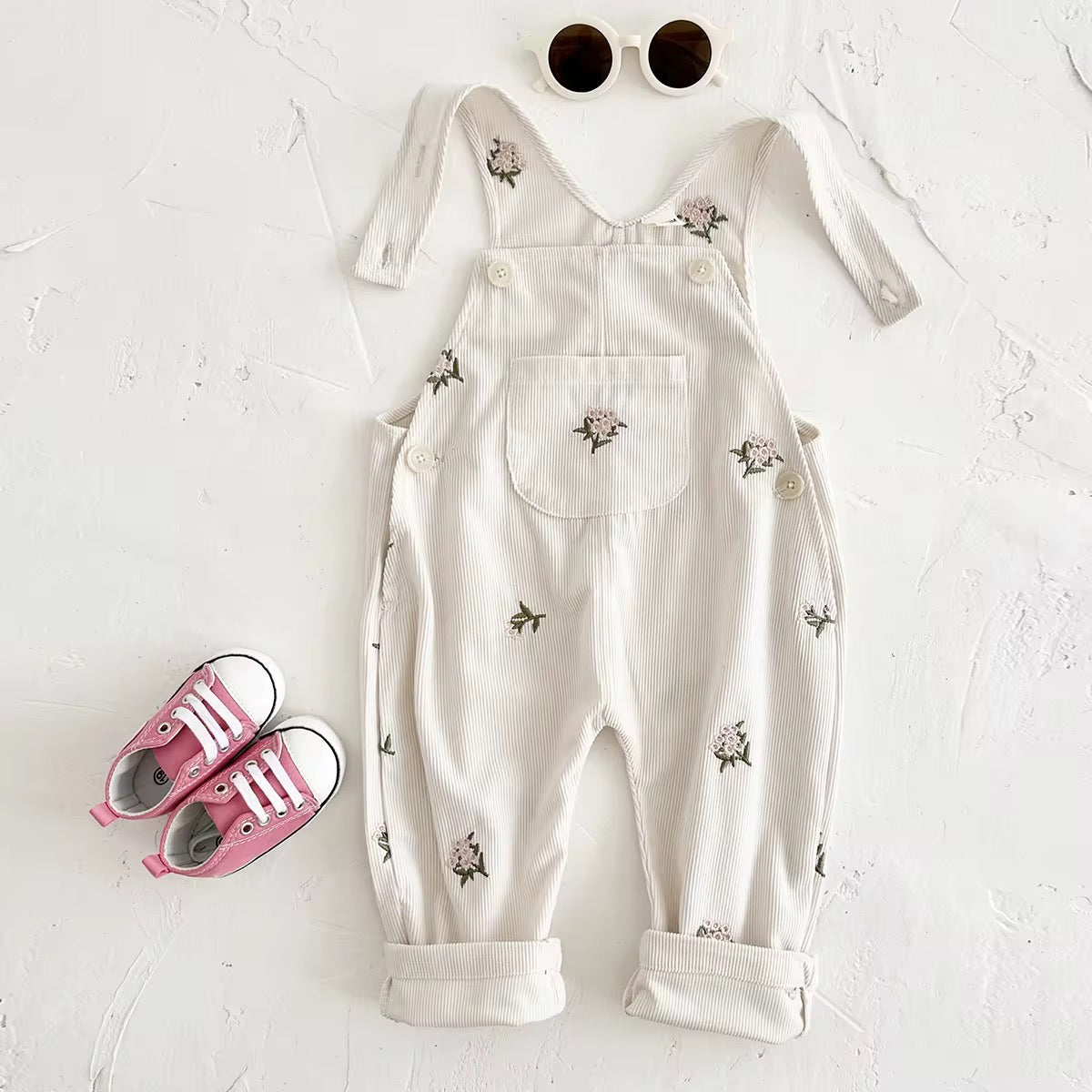 White overalls with floral patterns